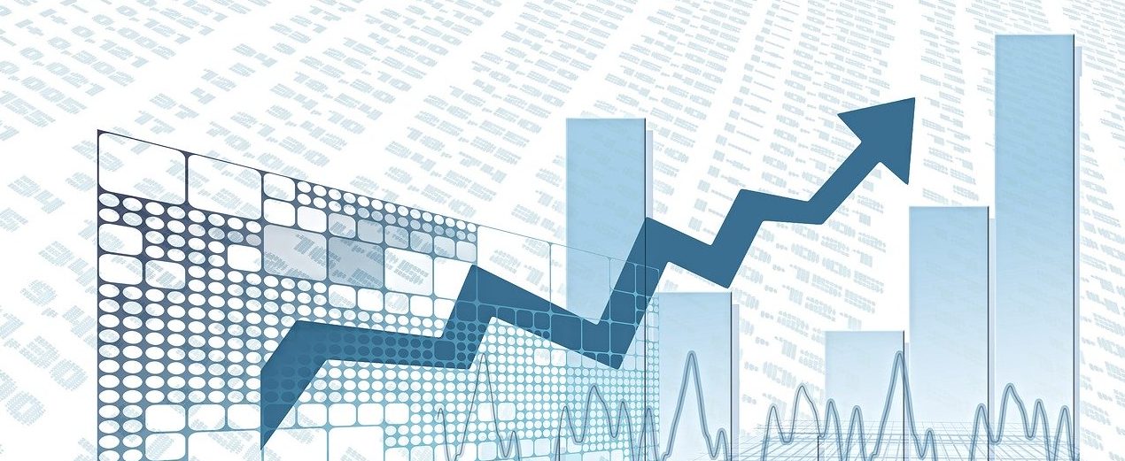 Ein Börsen-Chart und Dollar-Noten